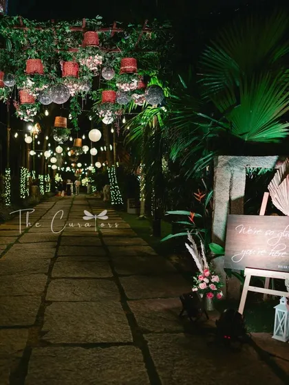 Your guests' experience begins the moment they arrive. We crafted this magical, fairy-lit pathway with hanging disco balls and rustic baskets to guide guests into an evening of celebration.