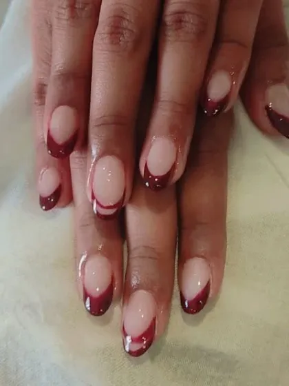A full set of the deep maroon French manicure, showing the elegant contrast on each nail.