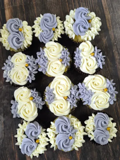 A classic and elegant choice, these cupcakes feature a beautiful combination of lavender and cream buttercream rosettes and flowers, finished with tiny gold pearls for a touch of sparkle.