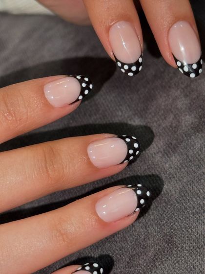 Cute, no? A playful twist on the French manicure with black tips and white polka dots.