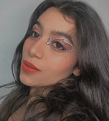 This look combines a classic winged liner with a creative swan-like design in white. It's a fun way to experiment with different shapes and styles.
