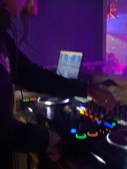 A close-up of my hands on the Pioneer DJ controller, making the magic happen.