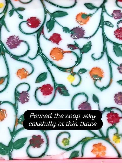 The process of carefully pouring soap into the handmade silicone mat.