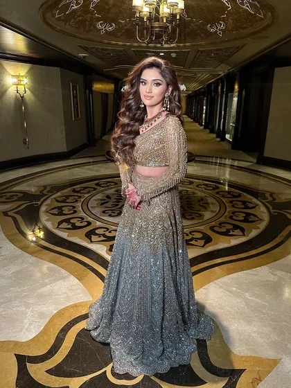 A stunning full-length shot of a client with voluminous open waves, perfect for a grand reception or cocktail gown.
