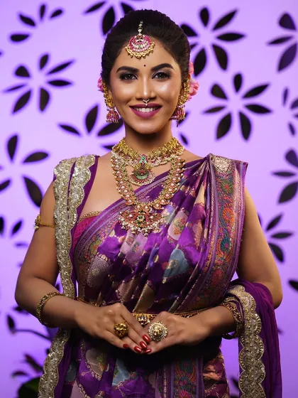 A stunning bridal portrait in a rich purple silk saree. I pay close attention to ensuring the pallu and pleats fall perfectly to complement the intricate blouse work and heavy temple jewellery.
