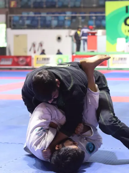 Working from the top in a Gi match. The focus is on breaking the opponent's posture and advancing my position.