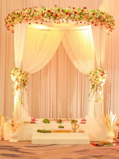 This elegant white mandap creates a heavenly space for your ceremony. The floral canopy and soft drapes are both classic and breathtaking.