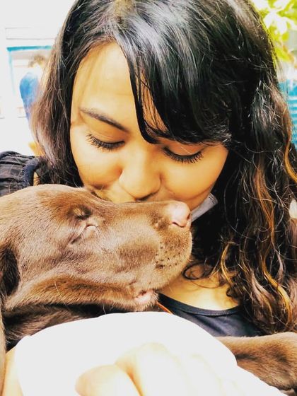 A sleepy puppy getting a gentle kiss. These are the quiet, tender moments that we cherish.