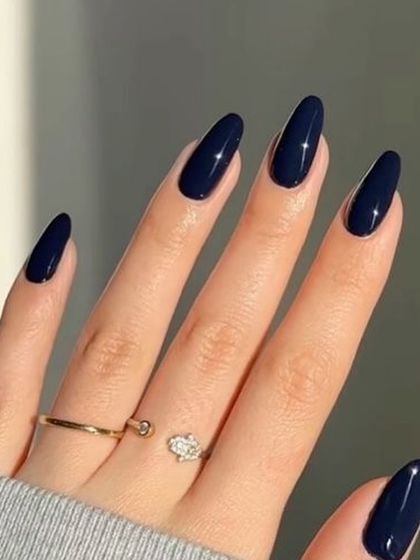 A deep, glossy navy blue. It's a bold and unexpected choice that is incredibly chic.