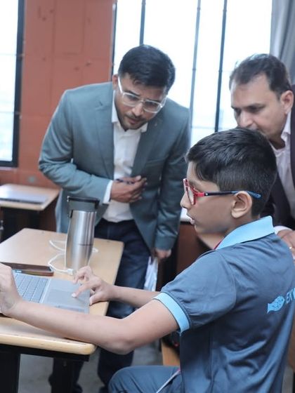 A young student explains his automation project to judges. Our curriculum is designed to push students beyond basic concepts and into advanced topics like automation and AI.