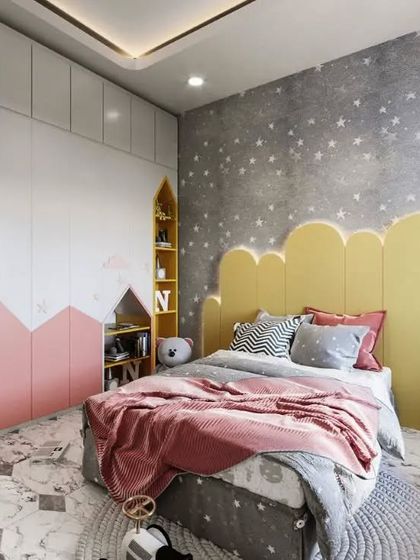 A charming girl's bedroom with a pink and yellow color scheme. The design features a cloud-shaped headboard, a mountain-themed wardrobe, and a starry accent wall, creating a whimsical and joyful space.