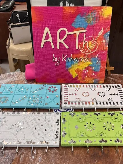 A display of the beautiful Lippan art key holders created during a 60th birthday party. This traditional art form adds an elegant and personal touch to any handmade item.