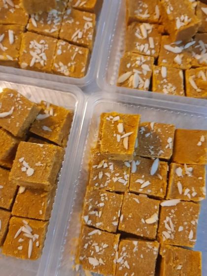 An overhead shot of four boxes filled with my delicious, homemade gluten-free Besan Barfi.