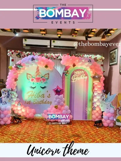 For a truly magical first birthday, I designed this dreamy unicorn theme. The setup includes a custom backdrop with the birthday girl's name, pastel pink balloon arrangements, and a light-up number '1' surrounded by unicorn cutouts.