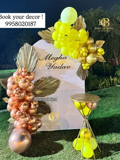 A vibrant and stylish outdoor birthday setup. This decor uses contrasting colors of rose gold and lime green balloons on a personalized white arched backdrop, creating a fresh and modern look.