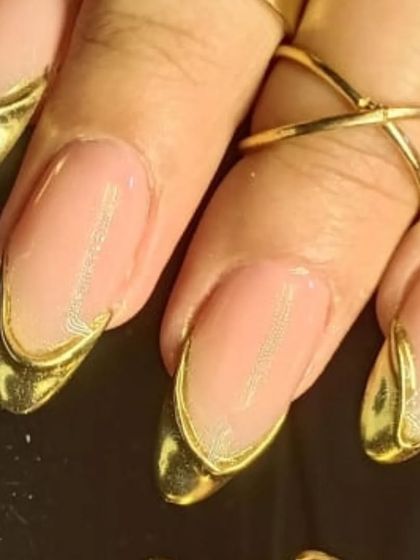 A detailed close-up of the sculpted gold chrome French tip, highlighting the unique 3D effect.