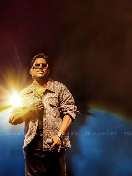 Our skills extend to high-energy live events. This dramatic shot of musician Yuvan Shankar Raja on stage, captured with dynamic lighting and smoke, shows our capability to handle large-scale concert photography.