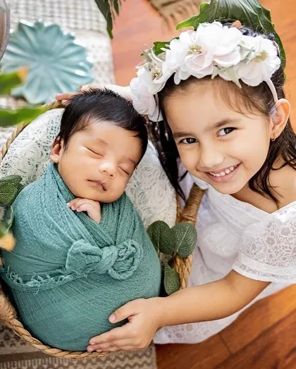 Welcoming a new baby is a special time for the whole family. I always make sure to capture the sweet bond between siblings, like this proud big sister with her new best friend.