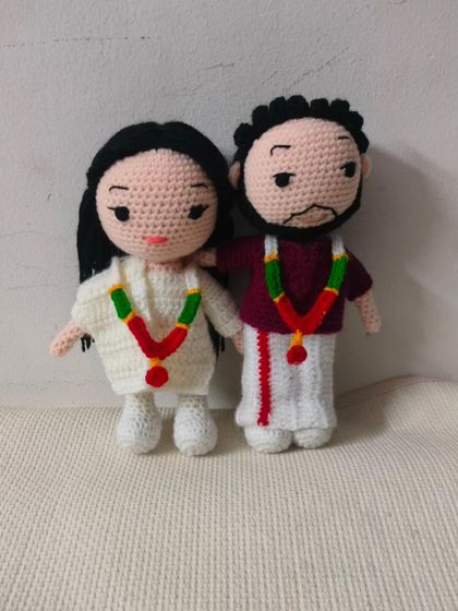 This is a South Indian wedding couple I made. The groom is in a traditional veshti and the bride is in a white saree with a beautiful garland. I love making dolls in different traditional dresses.
