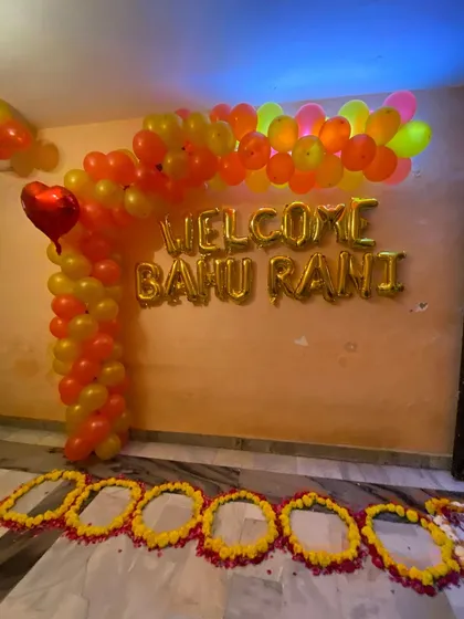 I also provide decorations for traditional ceremonies, like this 'Welcome Bahu Rani' setup for a newlywed bride. This features a custom balloon arch in festive colors and foil lettering to create a memorable welcome home moment for the new family member.