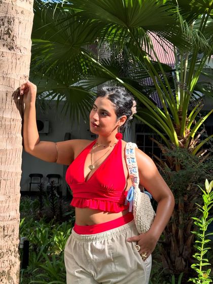 Another angle of the red bikini look, showing off the crochet bag and layered necklaces.