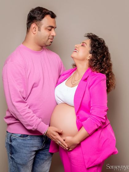 A joyful, candid moment between the couple, both coordinating in pink. This photo is full of laughter and love.