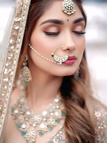 A beautiful shot focusing on the bridal nath and choker. Renting allows you to wear heavy, statement jewellery without the high cost.
