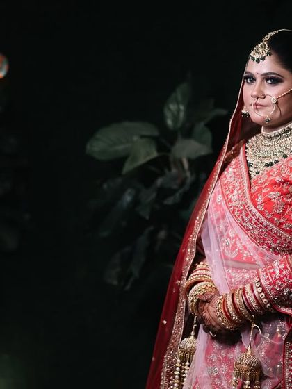 A classic bridal portrait with dramatic lighting. The bride's confident gaze and stunning jewelry are the focus of this powerful image.