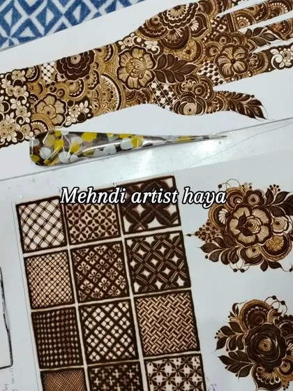 This is what my workspace looks like during a class. You can see a completed practice hand, a sheet of filler drills, and a fresh henna cone, ready for the next lesson.