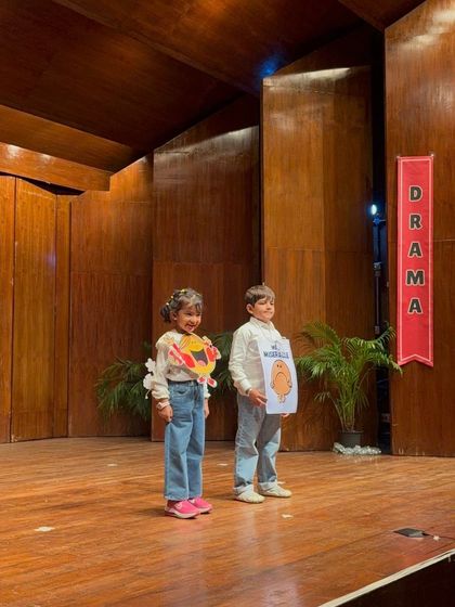 This pair proudly displays their character props, smiling after a successful performance.
