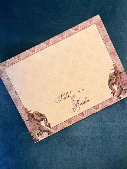 This design uses traditional elephant motifs on the envelope, setting a regal tone from the moment the invitation is received.