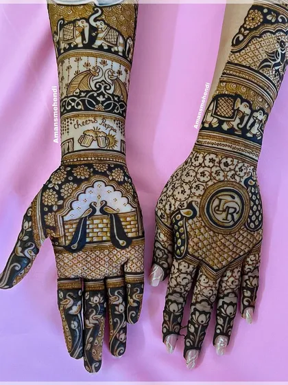 A unique bridal design that blends tradition with personal touches. The hands feature peacocks, elephants, and a "Cheers" motif, along with the couple's initials "LR".