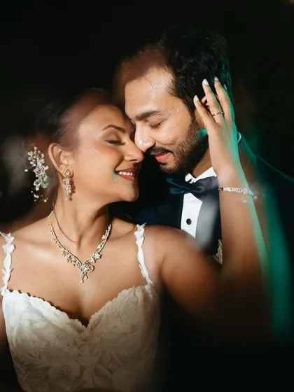 A close-up portrait from the wedding day, filled with warmth and emotion. The soft focus and subtle light flares create a dreamy, magical atmosphere around the couple as they share an intimate moment.