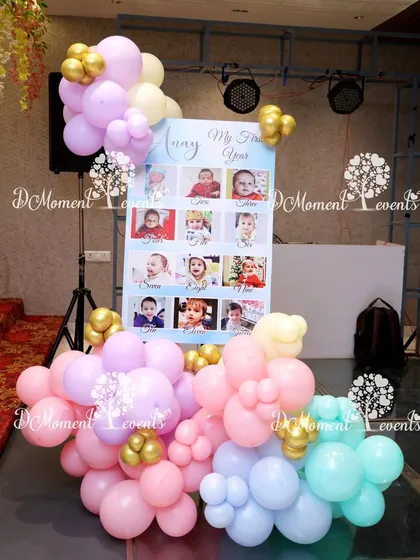 A "My First Year" milestone photo board for a Candyland-themed party. The display is surrounded by a colorful assortment of pastel balloons, adding a sweet and personal touch.