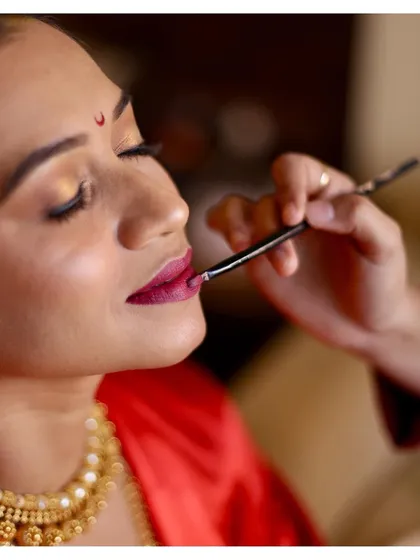 This is a close-up of a precise lip application. Learning this technique helps prevent feathering and ensures your lipstick wears evenly throughout the day, a skill you can use forever.