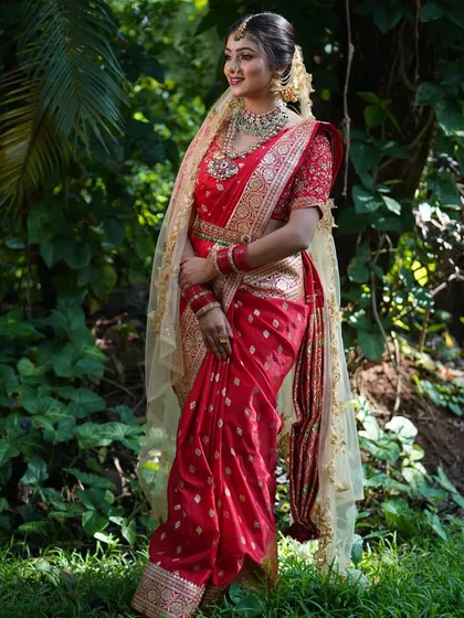 There is a special place in my heart for traditional wear. This client looks absolutely radiant in a classic red bridal saree from my collection, perfect for a wedding ceremony or a traditional photoshoot. The intricate gold work is timeless.