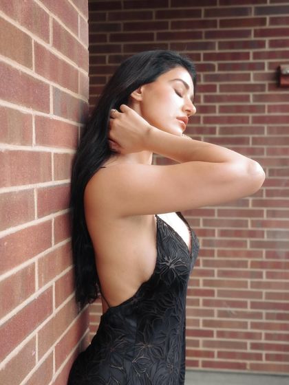 A side profile shot against a brick wall in New York. This image captures the effortless elegance of the hair and makeup I did for Disha's NYFW outing.