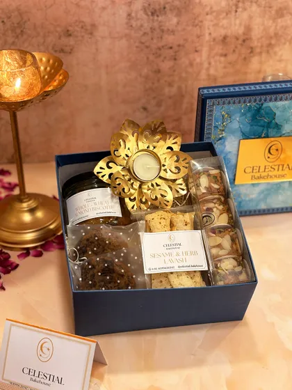 The 'Diwali Joy Box' is a perfect mix of sweet and savory. It pairs our healthy treats with a beautiful lotus metallic candle to illuminate your festive celebrations.