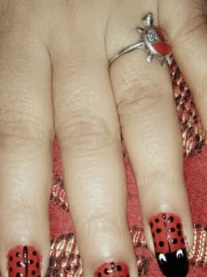 A creative ladybug design for our nail art service. Our artists can do fun and imaginative designs that kids love.
