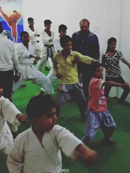 A mixed group of young students practicing their stances in the dojo. We welcome children of all ages and skill levels, creating an environment where everyone can learn and grow together.