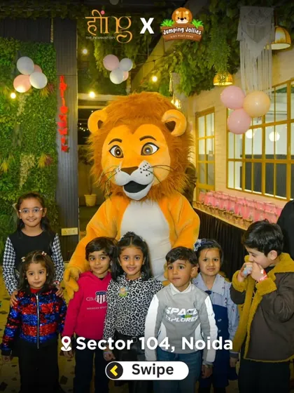 A group of children posing for a photo with the lovable lion mascot. He's always ready for a picture and brings smiles to everyone's faces.