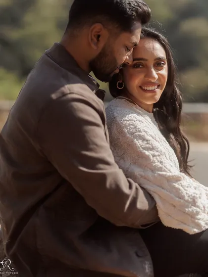A close-up of their embrace, where she looks directly at the camera. This creates a lovely, engaging portrait that invites the viewer into their happy moment.