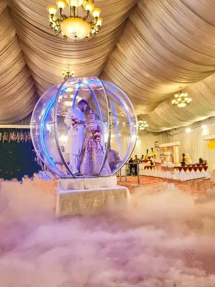 A still shot of the Crystal Ball entry, showing how the couple is encased in the illuminated sphere amidst a sea of low fog. This rental is perfect for indoor banquet halls and creates a magical atmosphere.