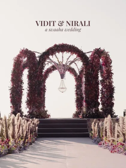 This wasn't just a mandap; it was a statement. For this beach wedding, I designed a dramatic, multi-arched structure covered in deep burgundy florals, creating a powerful, moody, and unforgettable altar against the bright sky. It's about bold vision and architectural floral design.