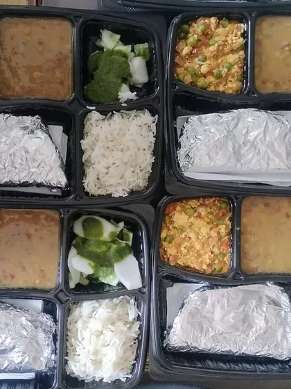 A large order of thalis with Paneer Bhurji and dal. You can see how each meal is consistently packed, which is very important for event catering.