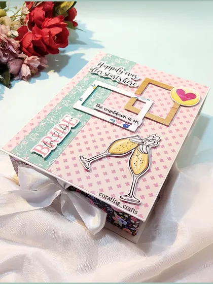 For the bride to be, because happily ever after starts here. This is the cover of a bridal scrapbook, designed with elegant details like champagne glasses to celebrate the countdown to the big day.