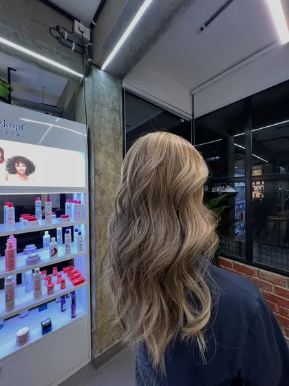 This lived-in ash blonde is a perfect example of a cool-toned balayage. The waves beautifully display the blend of ashy and light blonde shades.