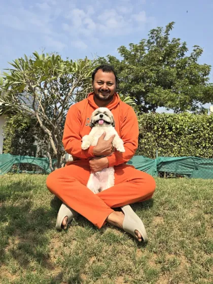 This is the most important part of my job: building trust. When you leave your bachha with me, my first priority is to make them feel safe and loved. A quiet moment on the grass with this little Shih Tzu is just as important as any training session.