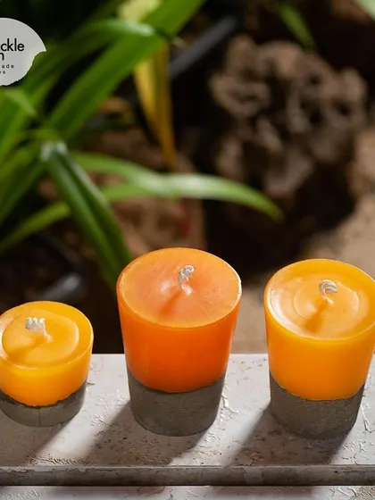 My concrete and wax pillar candles are perfect for outdoor or garden decor. These ones have a bright citrus scent to match their cheerful orange color.