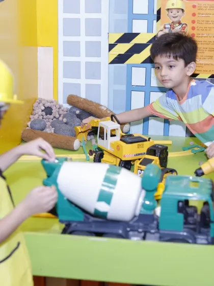 Kids getting hands-on in the construction play zone during a themed party. It's interactive fun that matches the decor.